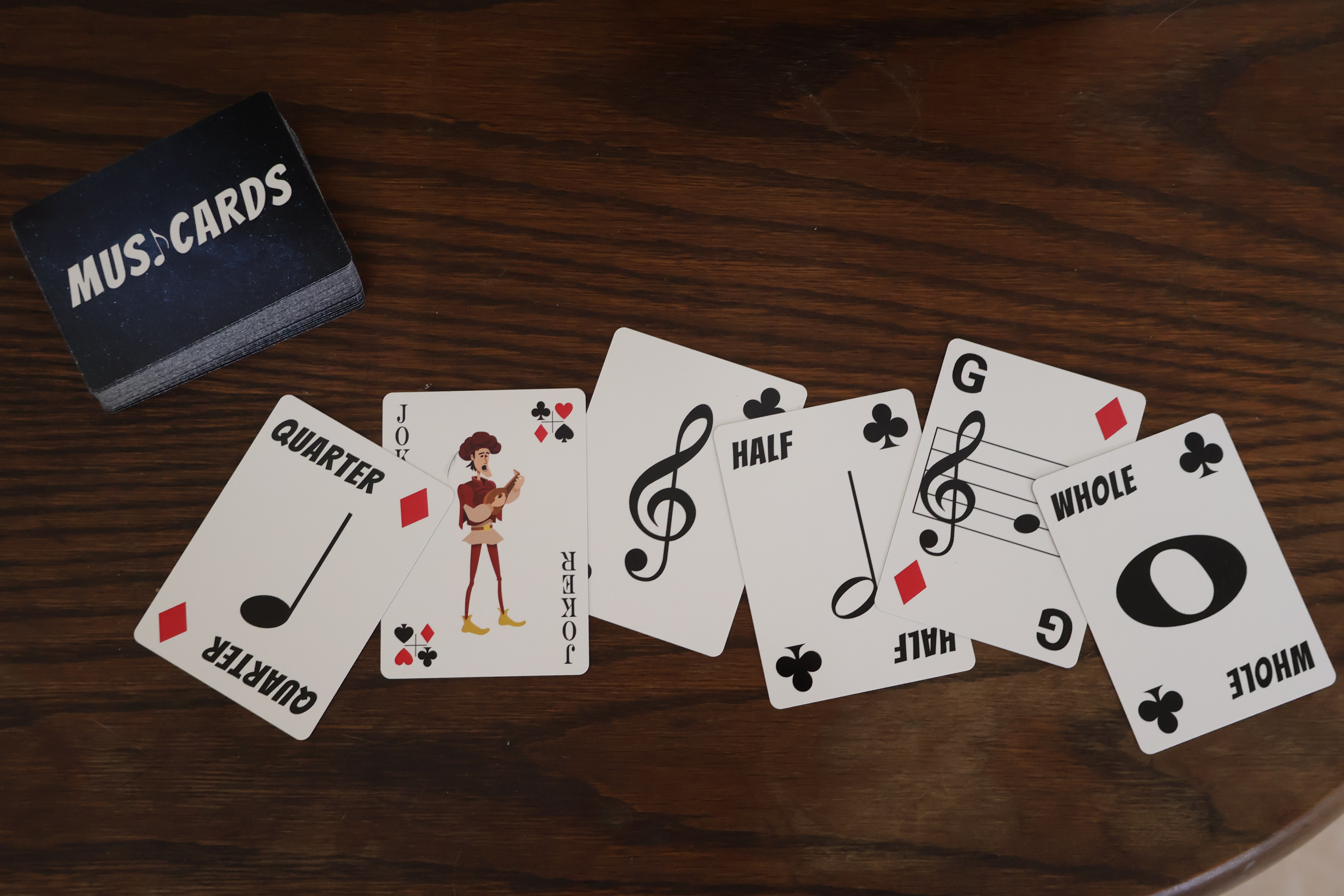 MusiCards fanned out showing Quarter, Joker, Ace, Half, G note, and Whole cards